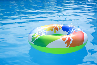 Inflatable ring in swimming pool on sunny day