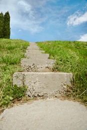 Outdoor concrete staircase up to hill, low angle view