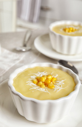 Delicious corn cream soup served on table