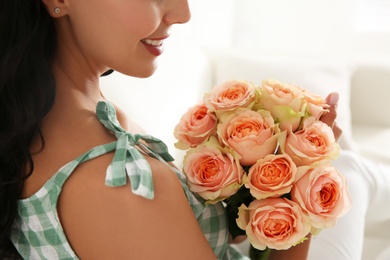 Young woman with beautiful bouquet indoors, closeup