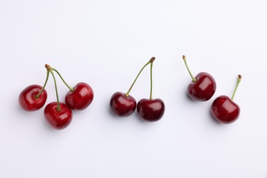 Photo of Many ripe sweet cherries on white background, flat lay