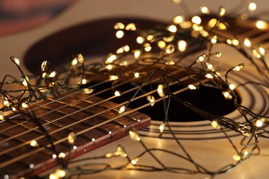 Photo of Closeup view of guitar with fairy lights
