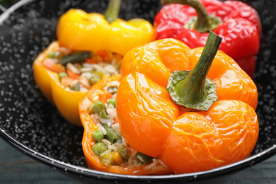 Tasty stuffed bell peppers in baking dish, closeup