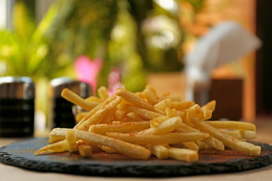 Delicious hot french fries served on table, closeup