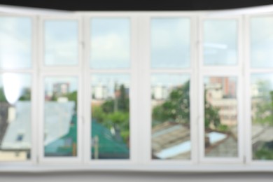 Blurred view of cityscape through white windows