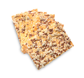 Stack of delicious crispy crackers with sunflower, flax and sesame seeds on white background, top view