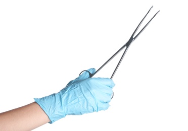 Doctor in sterile glove holding medical forceps on white background
