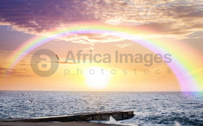 Beautiful view of colorful rainbow in sky over sea