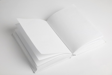 Open book with blank pages on white background