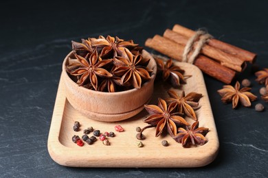 Aromatic anise stars and spices on black table
