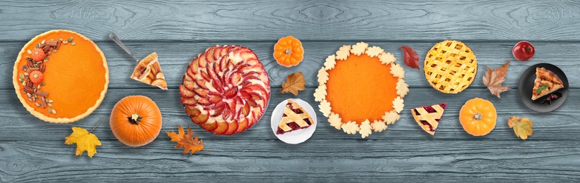 Flat lay composition with different tasty pies on wooden table. Banner design