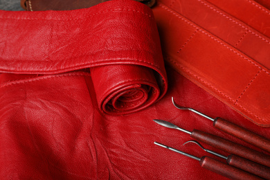 Set of craftsman tools on leather surface, closeup view