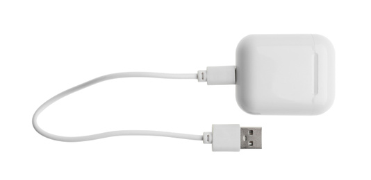 USB charge cable and wireless earphone case on white background. Modern technology