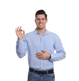 Happy healthy man touching his belly on white background