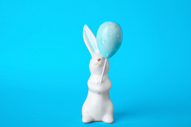 Bunny ceramic figure as Easter decor on blue background