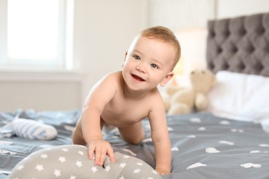 Photo of Adorable little baby on bed at home
