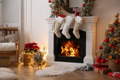 Fireplace with Christmas stockings in beautifully decorated living room