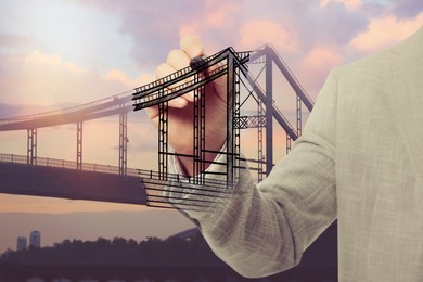 Image of Man drawing picture of bridge, closeup. Business cooperation concept