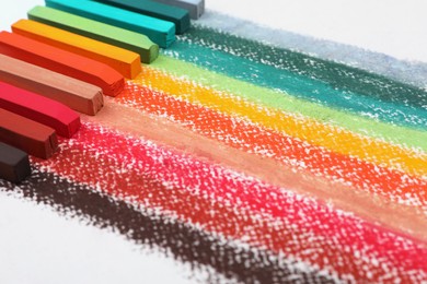 Colorful pastel chalks on white background, closeup. Drawing materials