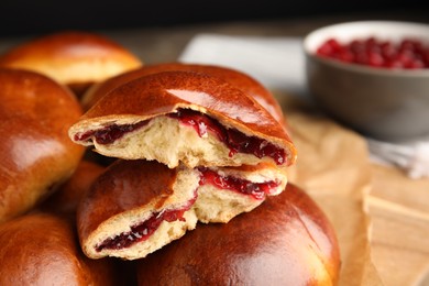 Photo of Baked cranberry pirozhki, closeup view. Delicious pastry