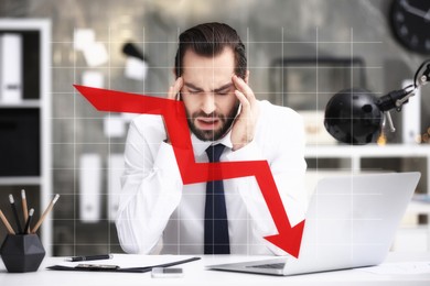 Stressed businessman at table in office and illustration of falling down chart. Economy recession concept