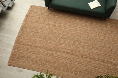 Beige carpet on wooden floor in living room, above view