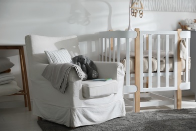 Baby room interior with crib and armchair. Idea for design