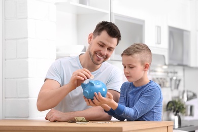 Family with piggy bank and money at home