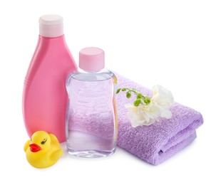 Photo of Baby oil, toiletries, flowers and toy duck on white background