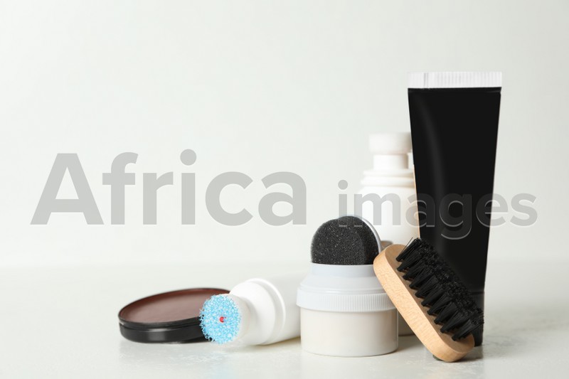 Composition with shoe care accessories on white background