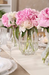 Photo of Stylish table setting with beautiful peonies indoors