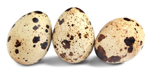 Three beautiful quail eggs on white background