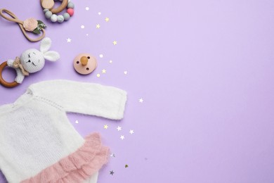 Photo of Baby clothes and accessories on lilac background, flat lay. Space for text