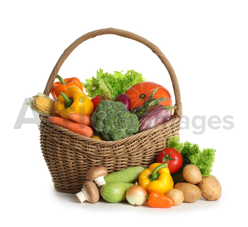 Photo of Wicker basket with fresh vegetables on white background