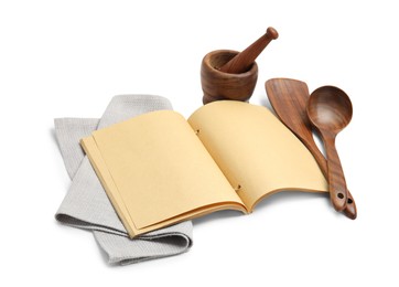 Blank recipe book, napkin and wooden utensils on white background. Space for text