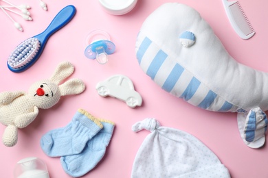 Flat lay composition with baby accessories and toys on color background