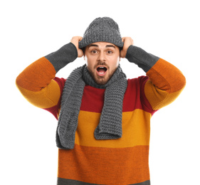 Emotional young man in warm clothes on white background. Winter vacation