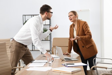 Emotional colleagues arguing in office. Toxic work environment
