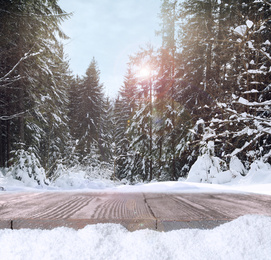 Wooden surface and beautiful view of winter landscape 