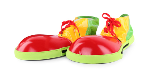 Photo of Funny colorful clown shoes with red laces isolated on white