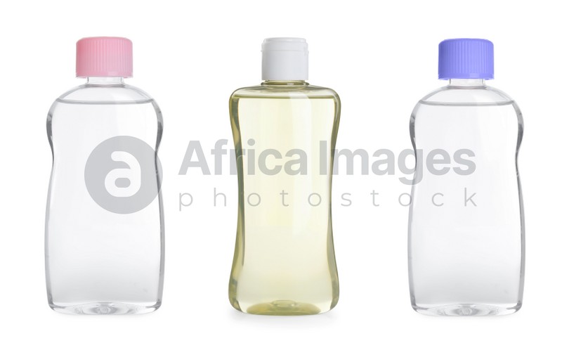 Set with bottles of baby oil on white background