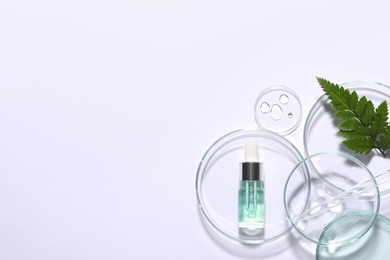 Organic cosmetic product, natural ingredient and laboratory glassware on white background, top view. Space for text