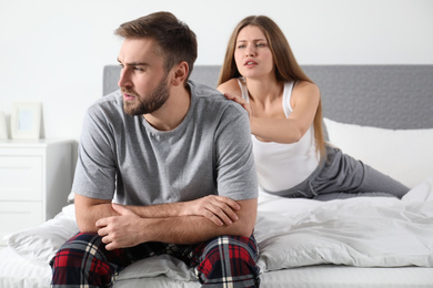 Young couple with relationship problems in bedroom