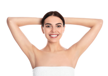 Young woman showing hairless armpits after epilation procedure on white background