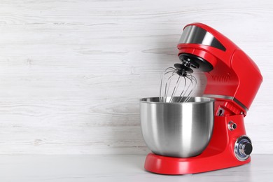 Photo of Modern red stand mixer on white marble table, space for text