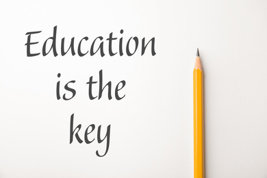 Phrase Education is the key and sharp pencil on white background, top view. Adult learning