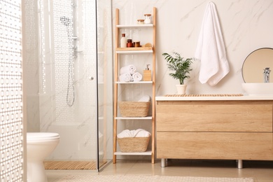 Photo of Modern bathroom interior with decorative ladder and shower stall