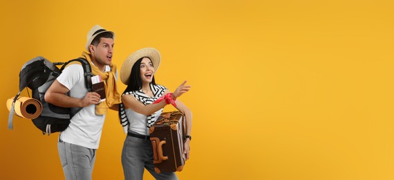 Emotional tourists with backpack and suitcase on yellow background