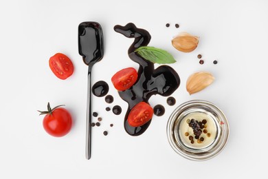 Photo of Organic balsamic vinegar and cooking ingredients on white background, flat lay