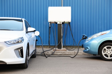 Photo of Charging modern electric cars from station outdoors